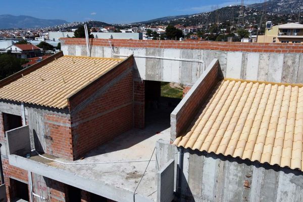 Σκεπή με κίτρινα κεραμίδια σε κτίριο στη Παλλήνη Αττικής